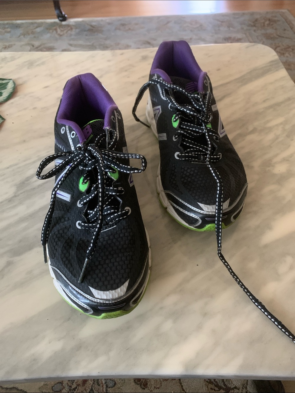New Balance Black Running Shoes with Purple Lining and Green Accents